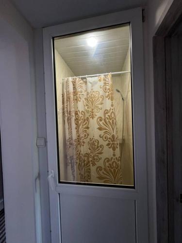 a door with a window with a shower curtain at SIGNEEV'S Villa in Kyiv