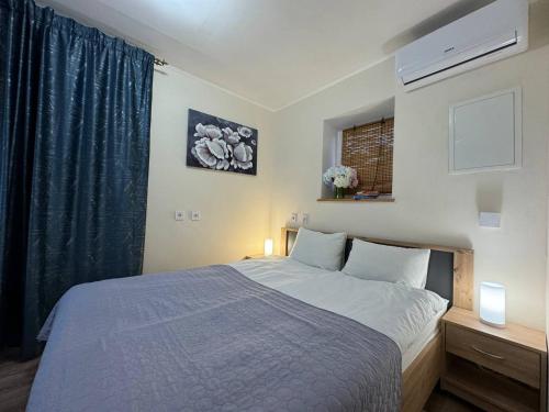 a bedroom with a large bed and a window at SIGNEEV'S Villa in Kyiv