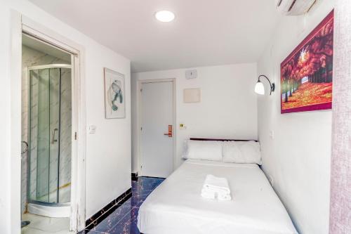 a white room with a bed and a window at SL Marbella in Marbella