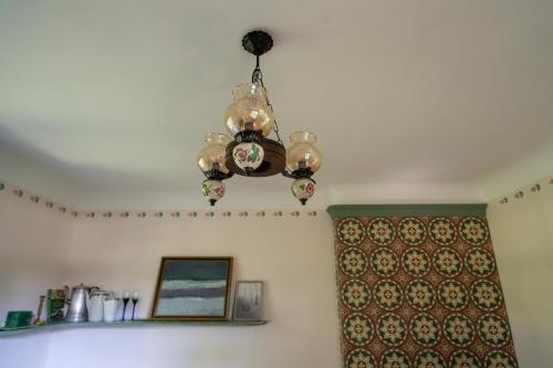 a chandelier hanging from the ceiling in a room at Ielejas A place for cool living in Vircava
