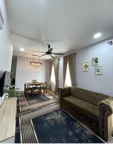 a living room with a couch and a table at Homestay D'Humairah kg Chabau JASIN in Jasin