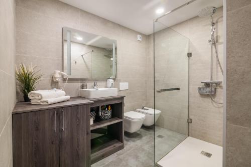 a bathroom with a sink and a toilet and a shower at Playa Paraiso apartment in Playa Paraiso