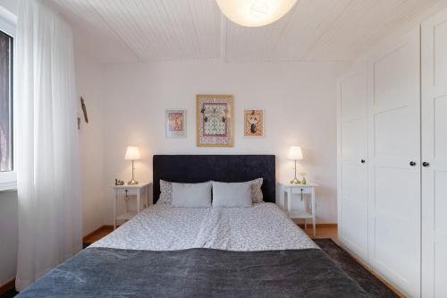 a bedroom with a large bed with two tables at Ferienwohnung Bachem in Bad Neuenahr-Ahrweiler