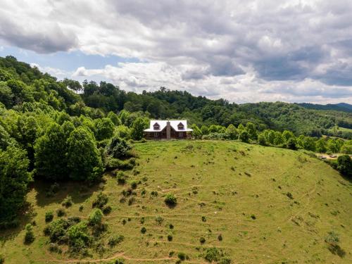 an aerial view of a house on a grassy hill at Mountain Range Retreat in Vilas