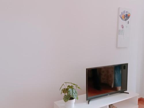 a flat screen tv sitting on top of a white shelf at Casa Nahara in Puerto del Rosario