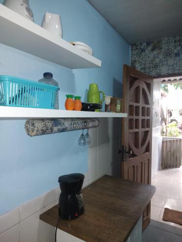 a kitchen with blue walls and a wooden counter top at Cantinho especial in Recife