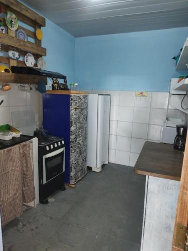 a kitchen with a stove and a refrigerator at Cantinho especial in Recife
