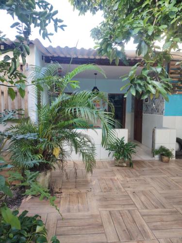 a courtyard with a wooden floor and plants at Cantinho especial in Recife