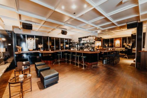 a bar with chairs and tables in a room at Post Seefeld - Wellnesshotel Tirol in Seefeld in Tirol