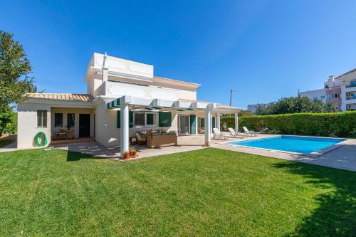 a villa with a swimming pool in a yard at VILLA DO VALE- Stunning Family Villa with Pool in Tavira