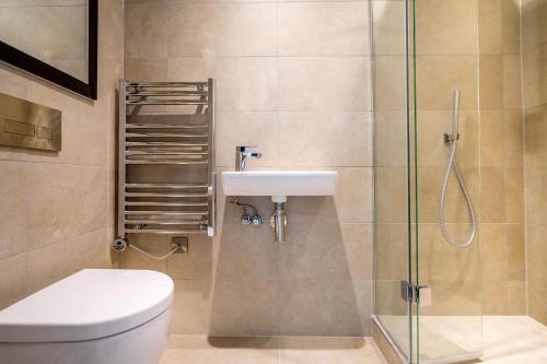 a bathroom with a toilet and a sink and a shower at River & Castle at Ryedale House in York