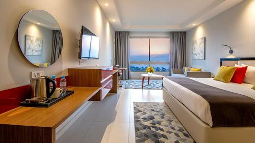 a hotel room with a bed and a mirror at The Ray Hotel and Studios in Beirut