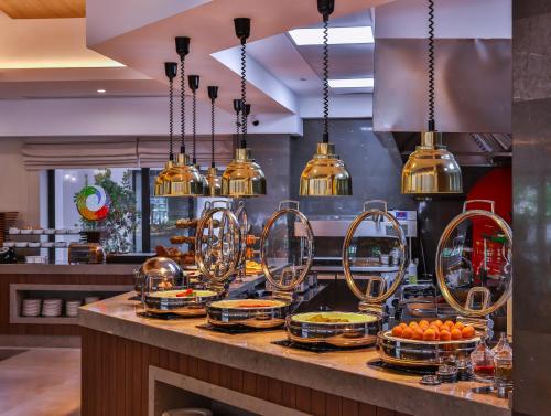 a kitchen with a counter with plates of food at Narven Wellness & Thermal Hotel in Yukarımahalle