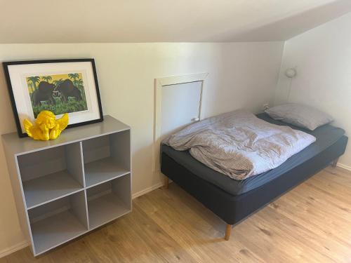 a bedroom with a bed and a dresser with a mirror at Fjelstrup Kro in Haderslev