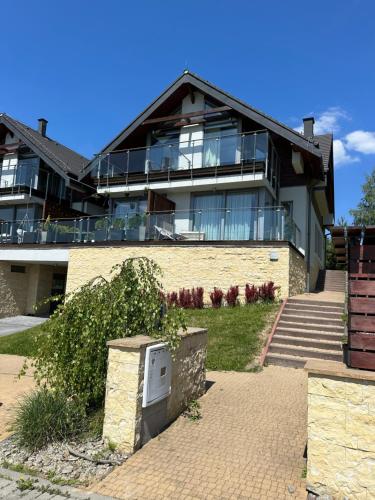 a large house with a large building with windows at Nowy apartament na polu golfowym Paczółtowice in Paczółtowice