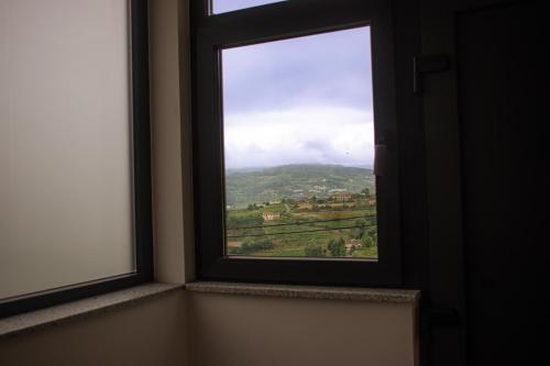 a window with a view of a mountain at Casa do Barreiro in Baião