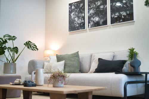 a living room with a couch and a coffee table at Elements Milfontes - Japandi Designed House - City Center in Vila Nova de Milfontes