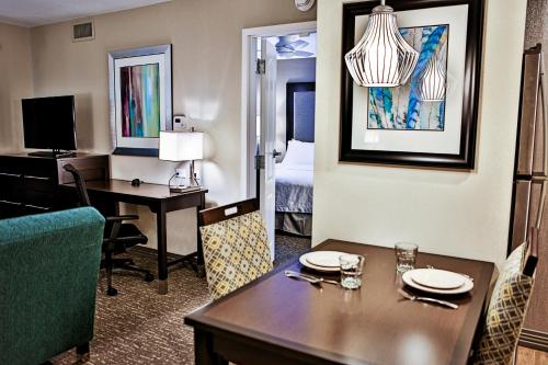 a hotel room with a dining table and a bedroom at Homewood Suites by Hilton Asheville in Asheville