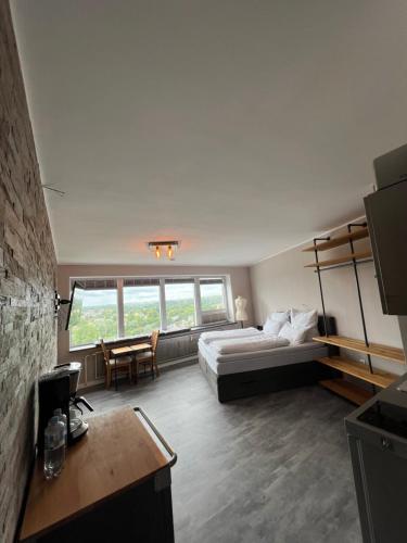 a bedroom with a bed and a desk and a table at Hafenblick in Schleswig