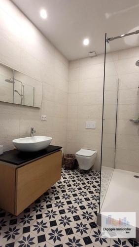 une salle de bain avec un lavabo, une baignoire et des toilettes dans l'établissement Ancienne Maison de Vigneron avec Jacuzzi - Uzès, à Sanilhac-et-Sagriès