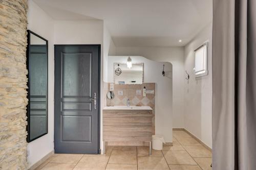 a bathroom with a blue door and a sink at Clos Saint-Michel Resort & Spa in Malaucène