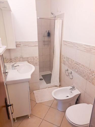 a bathroom with a shower and a toilet and a sink at Casa dei Trabocchi 2-3 in San Vito Chietino