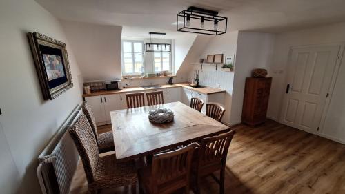 a kitchen with a table and chairs in a room at Leipa Apart in Česká Lípa