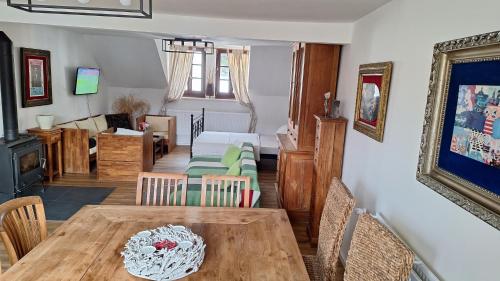 a dining room and living room with a table and chairs at Leipa Apart in Česká Lípa