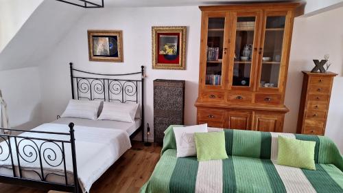 a bedroom with two beds and a couch at Leipa Apart in Česká Lípa