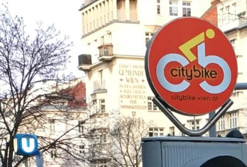 a sign for a city bike in front of a building at Yuki's Place - UN-VIC, Danube Beach and Subway near to Downtown Vienna in Vienna