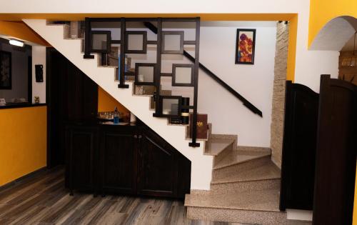 a stairway with a black and white stair case at Casa Stejarul Lui Andrei in Izvoarele