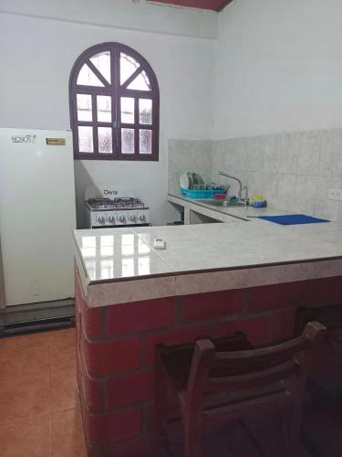 a kitchen with a counter with a sink and a refrigerator at Donde Rafa in Maracay
