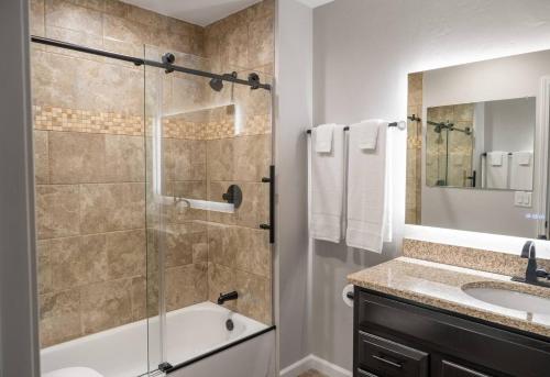 a bathroom with a shower and a tub and a sink at Jesse James and Billy the kid in Hermann