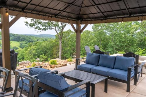 a patio with blue furniture and a table and chairs at Entire Hermann Hideout in Hermann