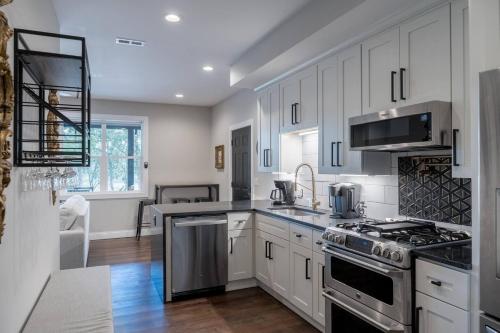 a kitchen with white cabinets and a stove top oven at Entire Hermann Hideout in Hermann