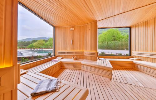 a sauna with benches and a large window at Narven Wellness & Thermal Hotel in Yukarımahalle