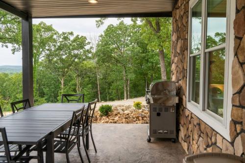 a patio with a table and chairs and a grill at Entire Hermann Hideout in Hermann