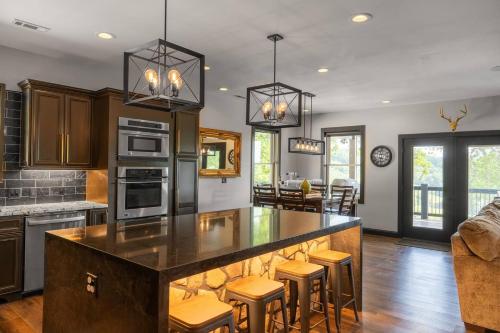 a kitchen with a large island with bar stools at Bonnie n Clyde and Jesse James in Hermann