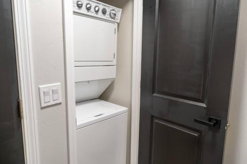 a kitchen with a white stove and a refrigerator at Entire Hermann Hideout in Hermann