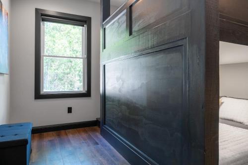 a large screen in a room with a bed and a window at Bonnie n Clyde and Jesse James in Hermann