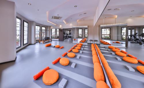 a large room with orange seats in a building at Narven Wellness & Thermal Hotel in Yukarımahalle