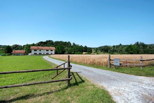 a dirt road with a fence next to a field of hay at Ant Ra Prina Verde in Sassello