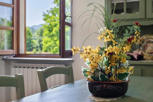 a vase filled with yellow flowers on a table at Ant Ra Prina Verde in Sassello