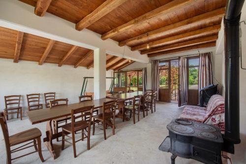 a dining room with a table and chairs and a wood stove at Ant Ra Prina Chiaro Pino in Sassello