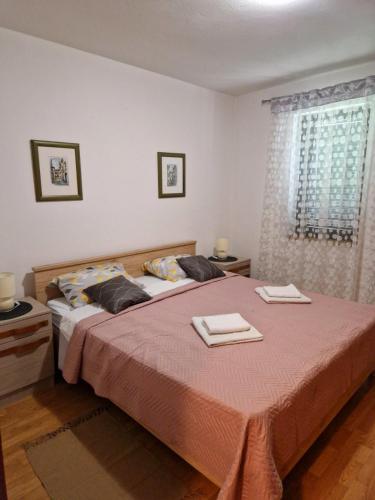 a bedroom with a bed with two towels on it at Apartman Seka in Kraljevica