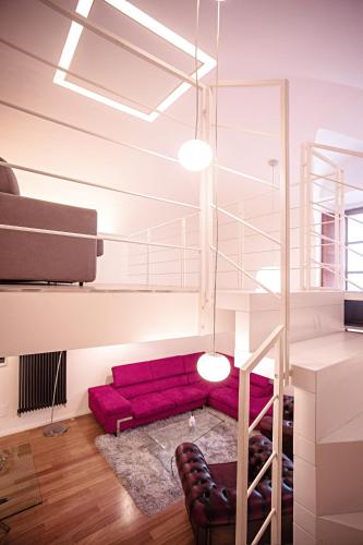 a living room with a red couch and a staircase at Pantheon Luxury Apartment in Rome