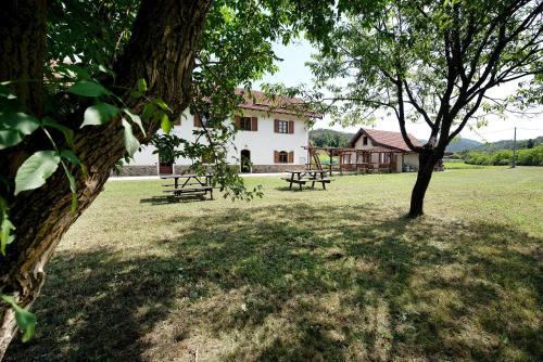 a park with two picnic tables and a building at Ant Ra Prina Chiaro Pino in Sassello