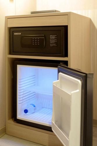 a microwave with its door open in a kitchen at Poshpacker Hotel in Taipei