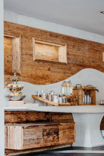 a counter in a kitchen with wooden walls at Post Seefeld - Wellnesshotel Tirol in Seefeld in Tirol