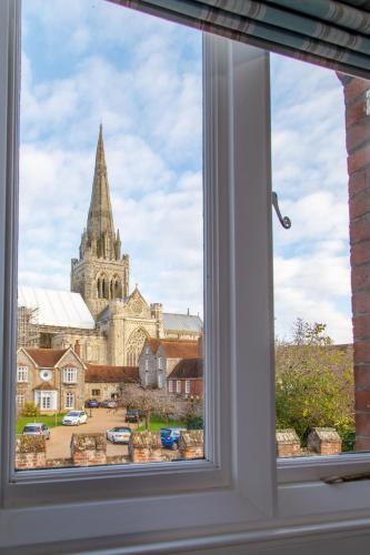 an open window with a view of a church at 4 Canon Lane in Chichester